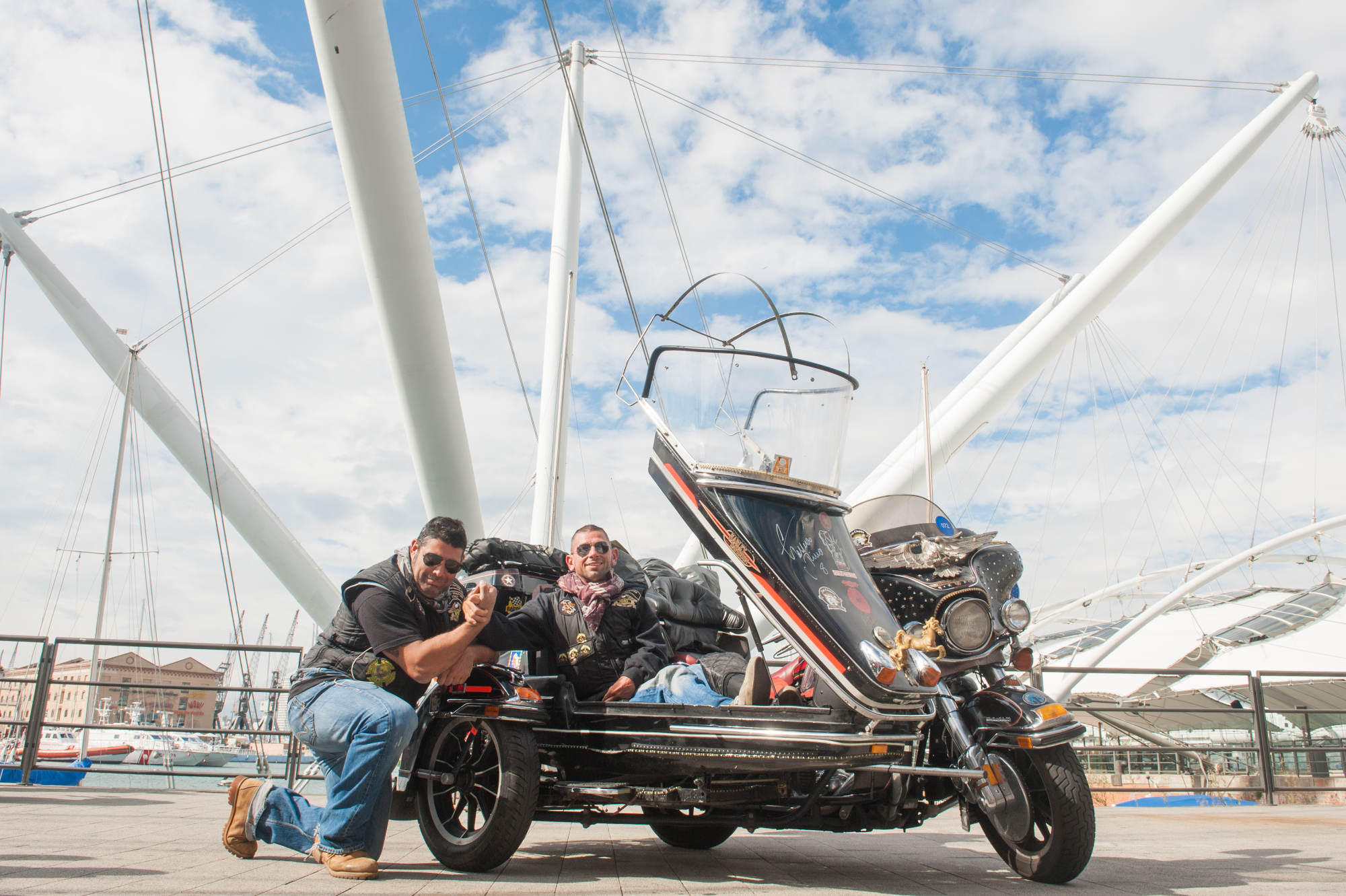 H.O.G. members posing with a Harley-Davidson motorcycle.