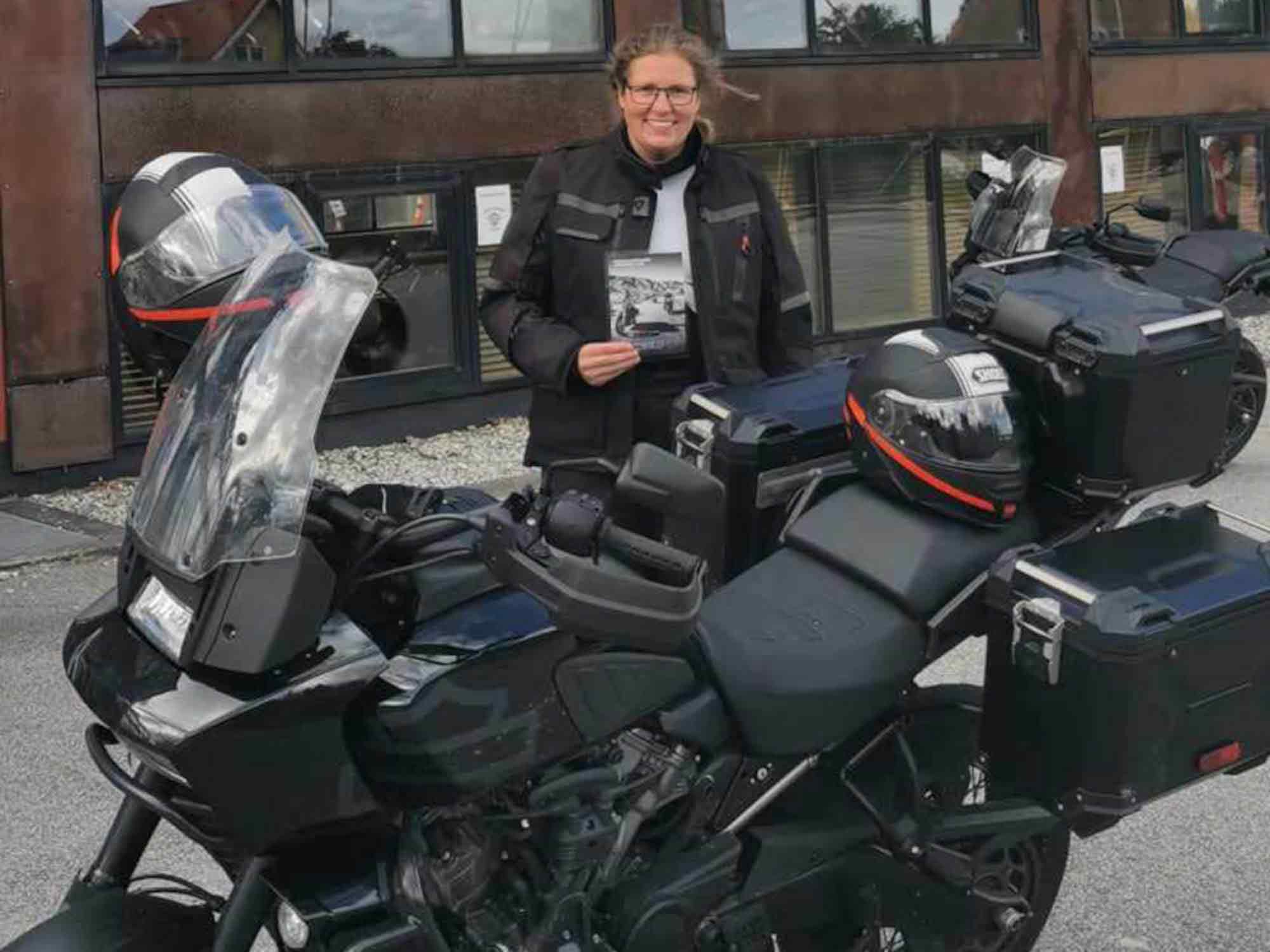 Camilla standing with her Harley-Davidson.