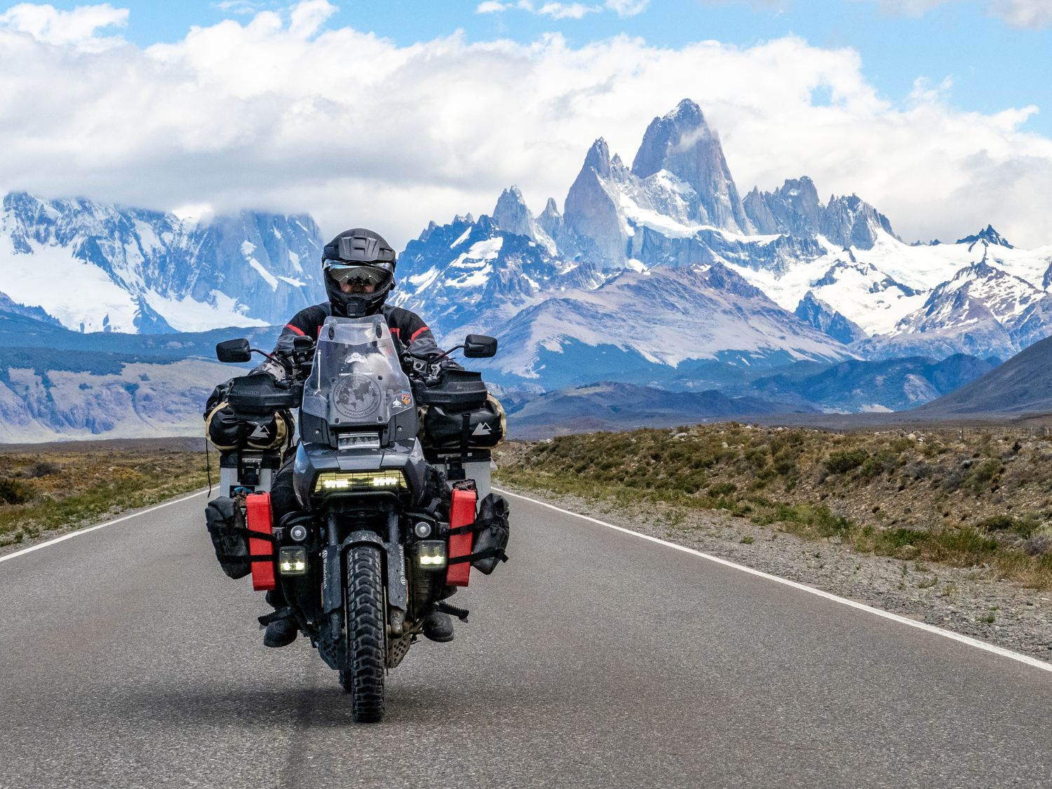 Riding a motorcycle in front of icy mountains in Argentina