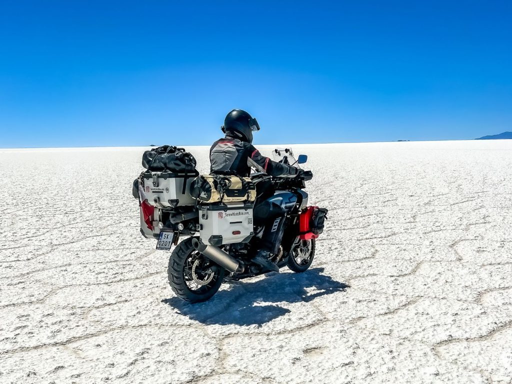 Riding a motorcycle across the saltflats in Dakar, Bolivia