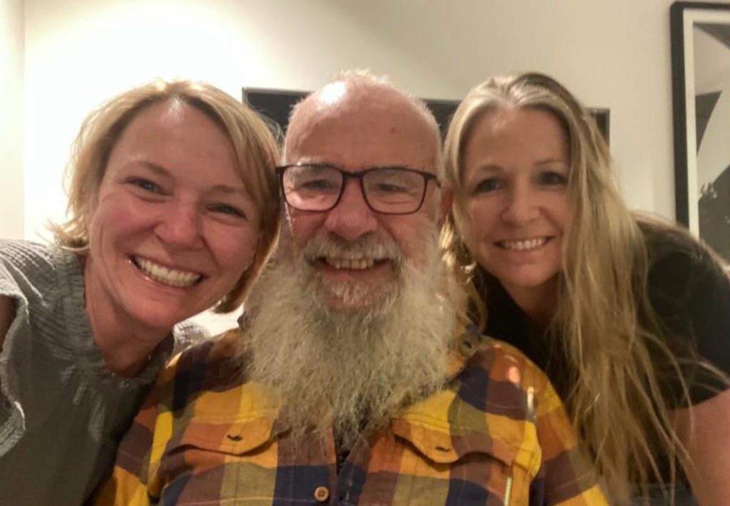 A picture of Bob with his daughters.