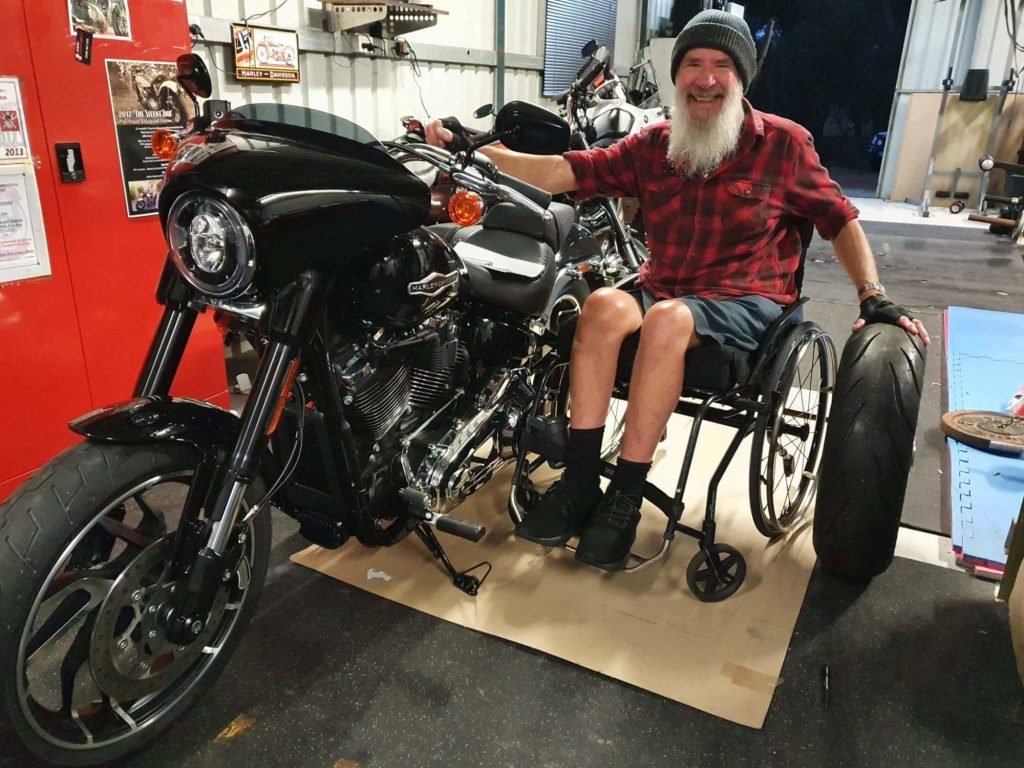 A picture of Bob sitting in the sidecar of a motorcycle.