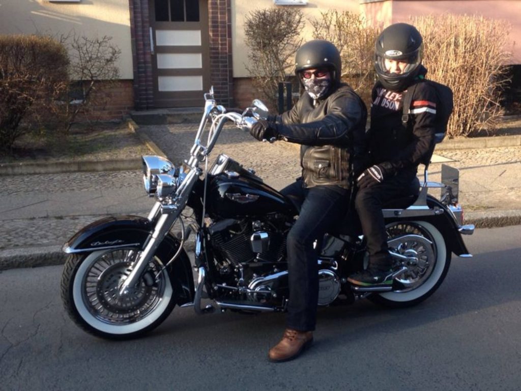A picture of two people on a motorcycle.