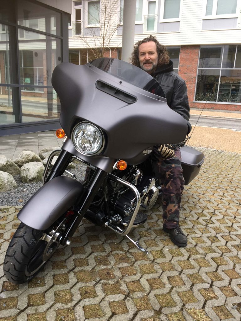 A picture of a H.O.G. member on a motorcycle.