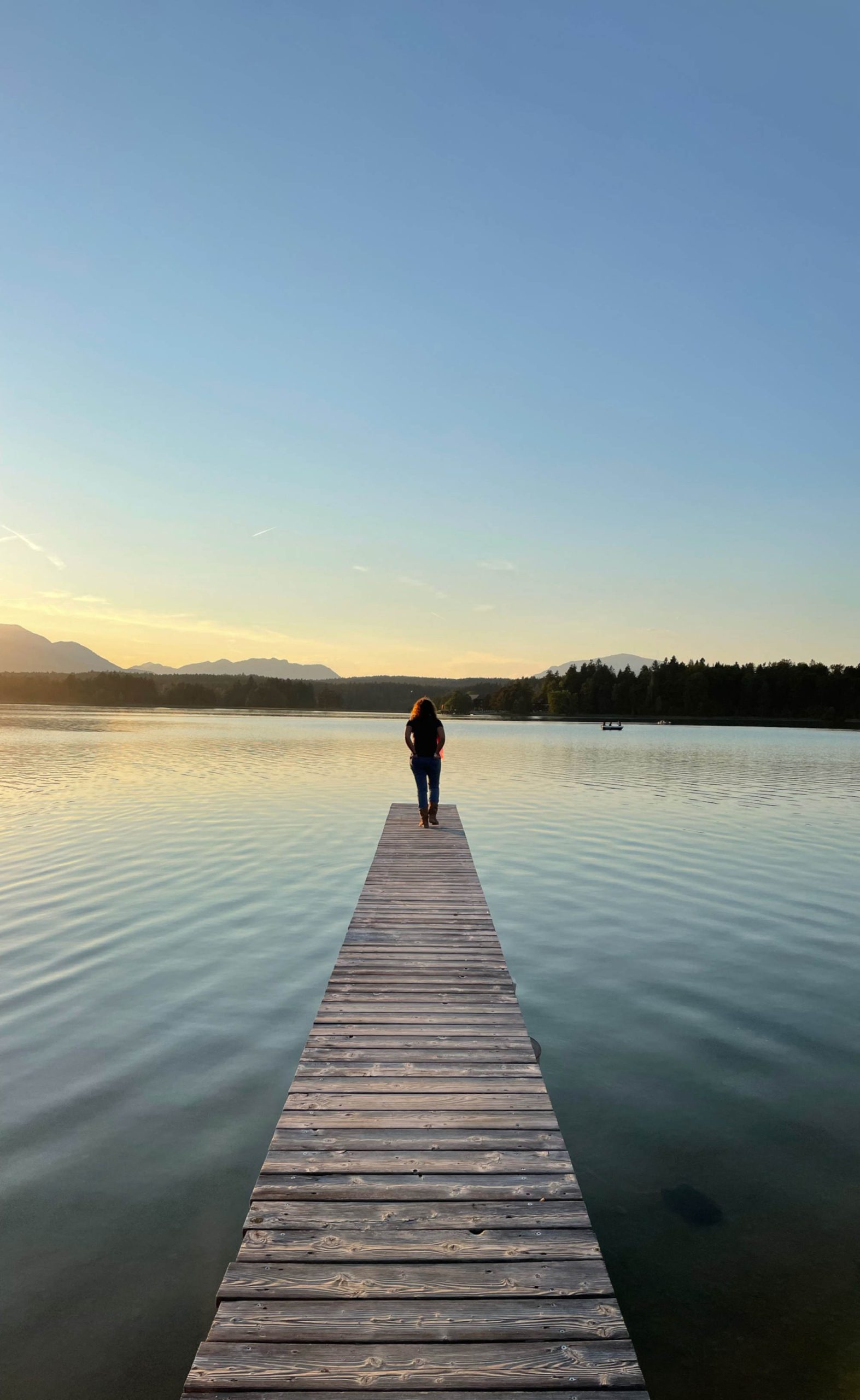 A picture of a woman standing on a pier.