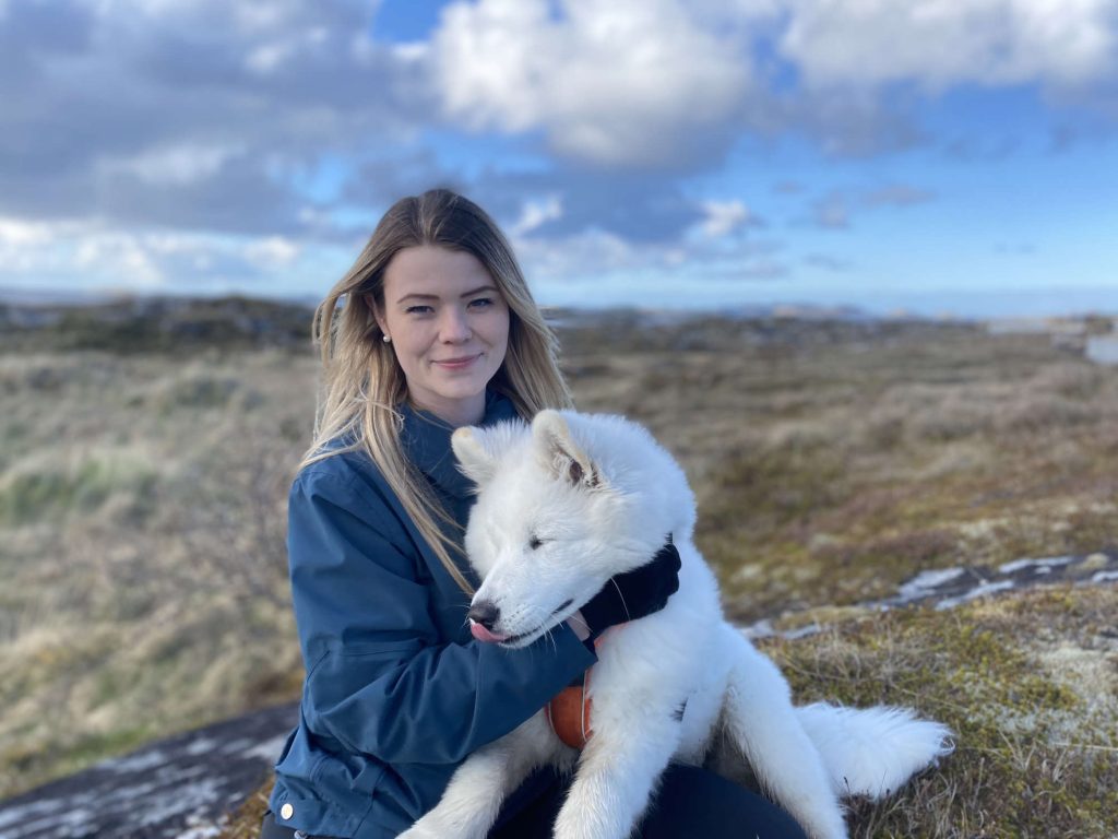 A picture of a girl and a dog.