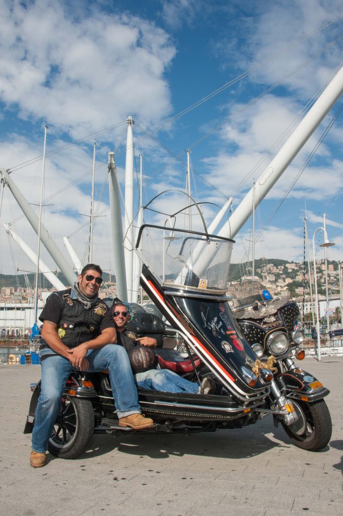 H.O.G. members posing with a motorcycle.