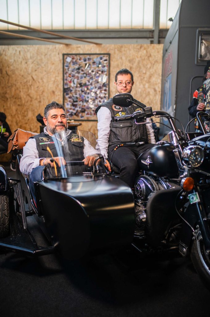 H.O.G. members sitting on a Harley-Davidson motorcycle.