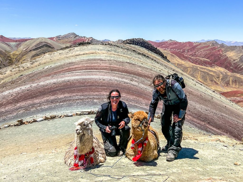 Ela and Greg Kedzior with two alpacas in Peru.