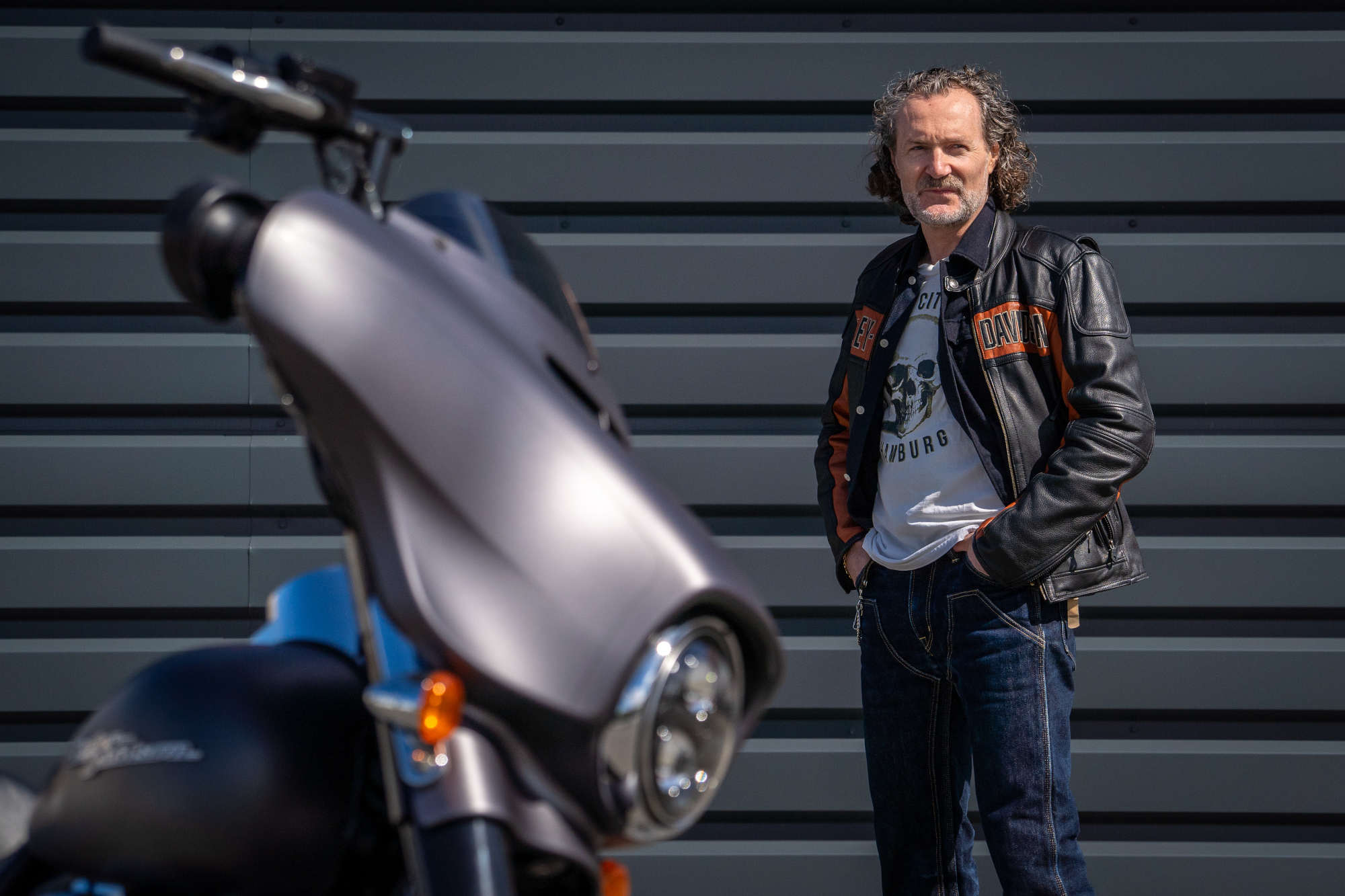 A H.O.G. member standing next to a motorcycle.