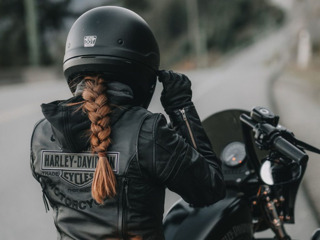 ANDRA NEDELCU pictured from behind in her motorcycle gear and HOG jacket.