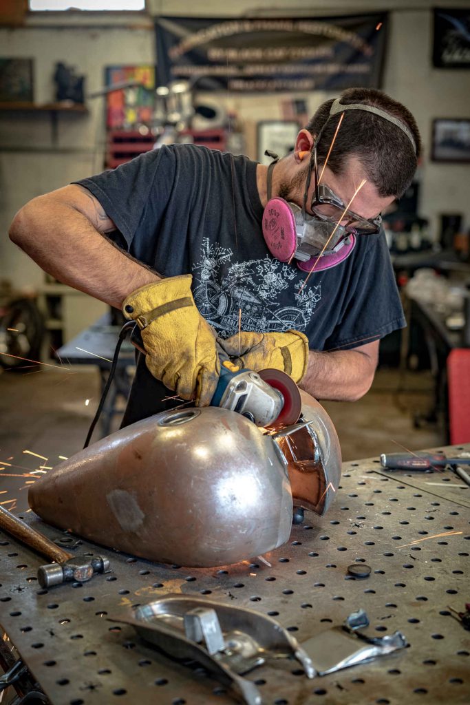 Person refurbishing a gas tank