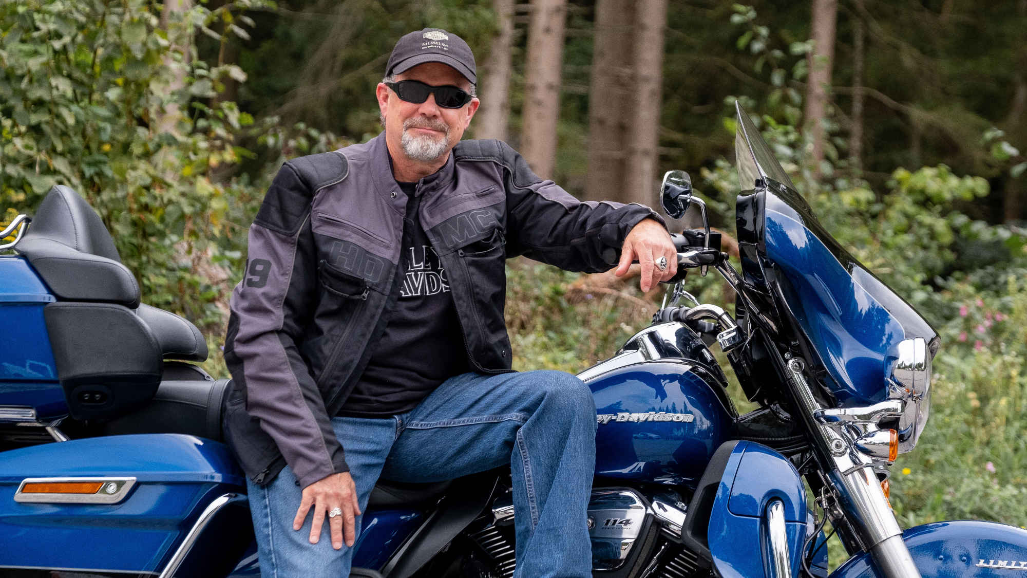 Bill Davidson taken with a Harley-Davidson motorcycle