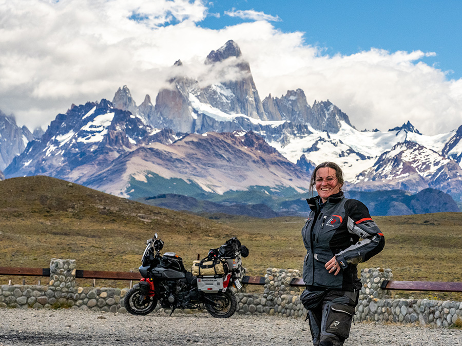 Ela standing in front of bike with mountain range in the background