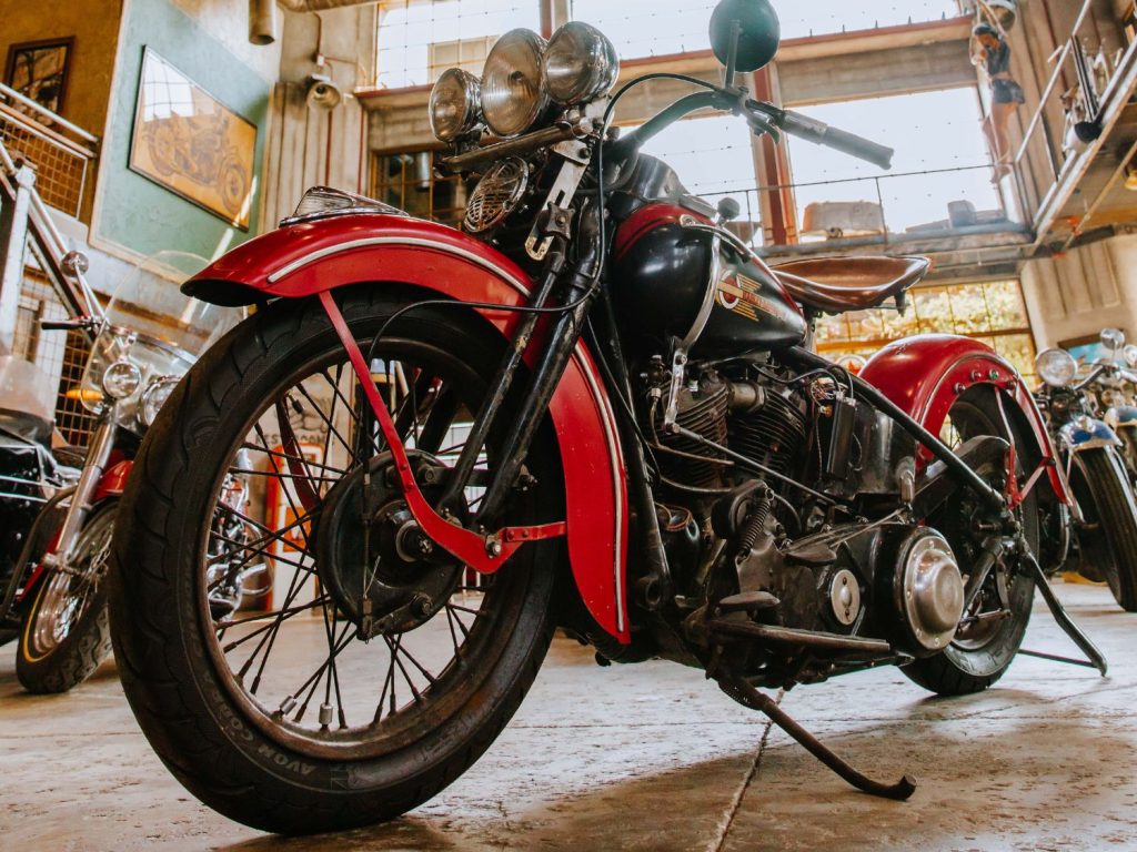 A close-up of a red Knucklehead Harley-Davidson.