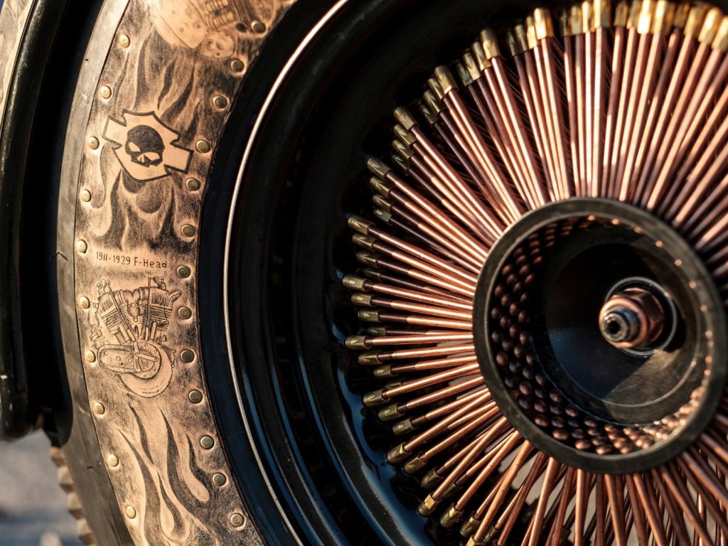 Tattooed leather on a Harley-Davidson wheel.