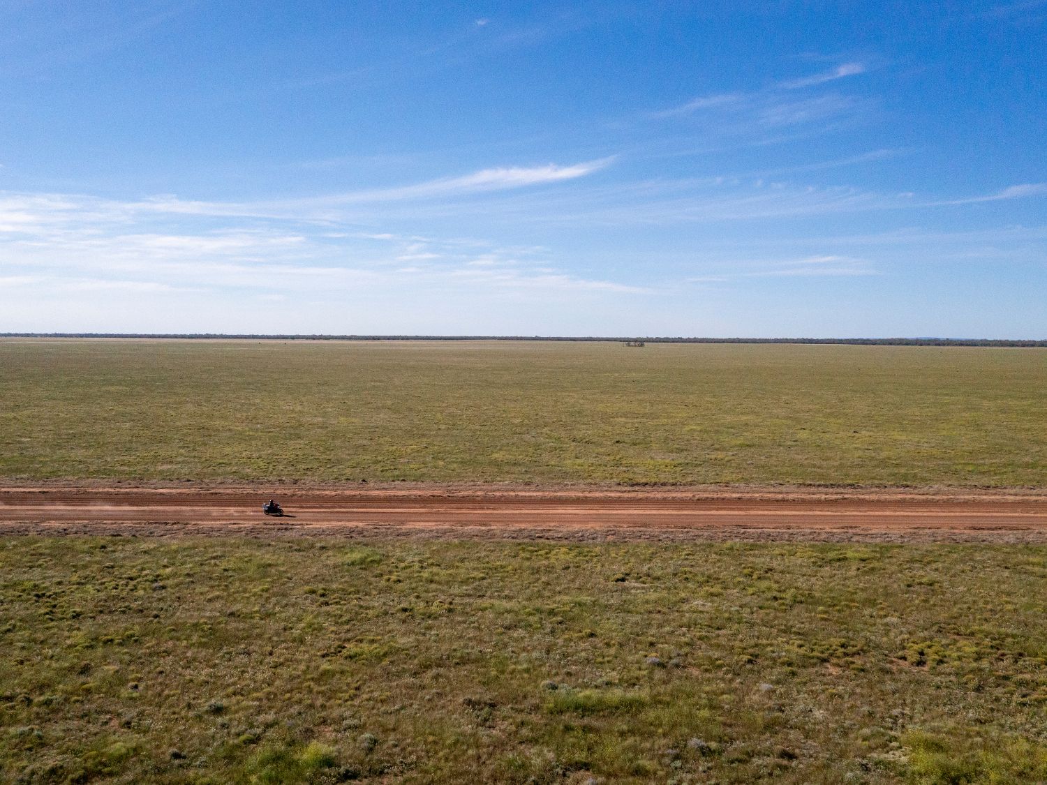 A motorcyclist on a Revolution®Max rides on an empty dirt track in Australia