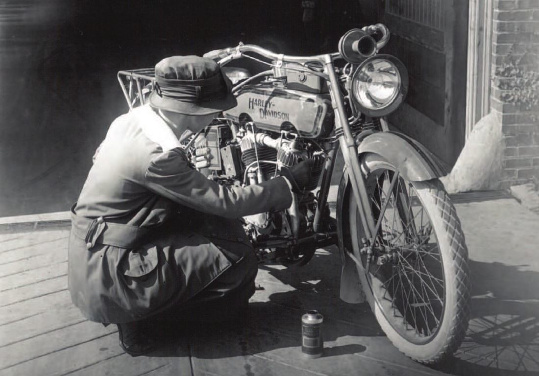 Lillian Hauerwas working on a motorcycle